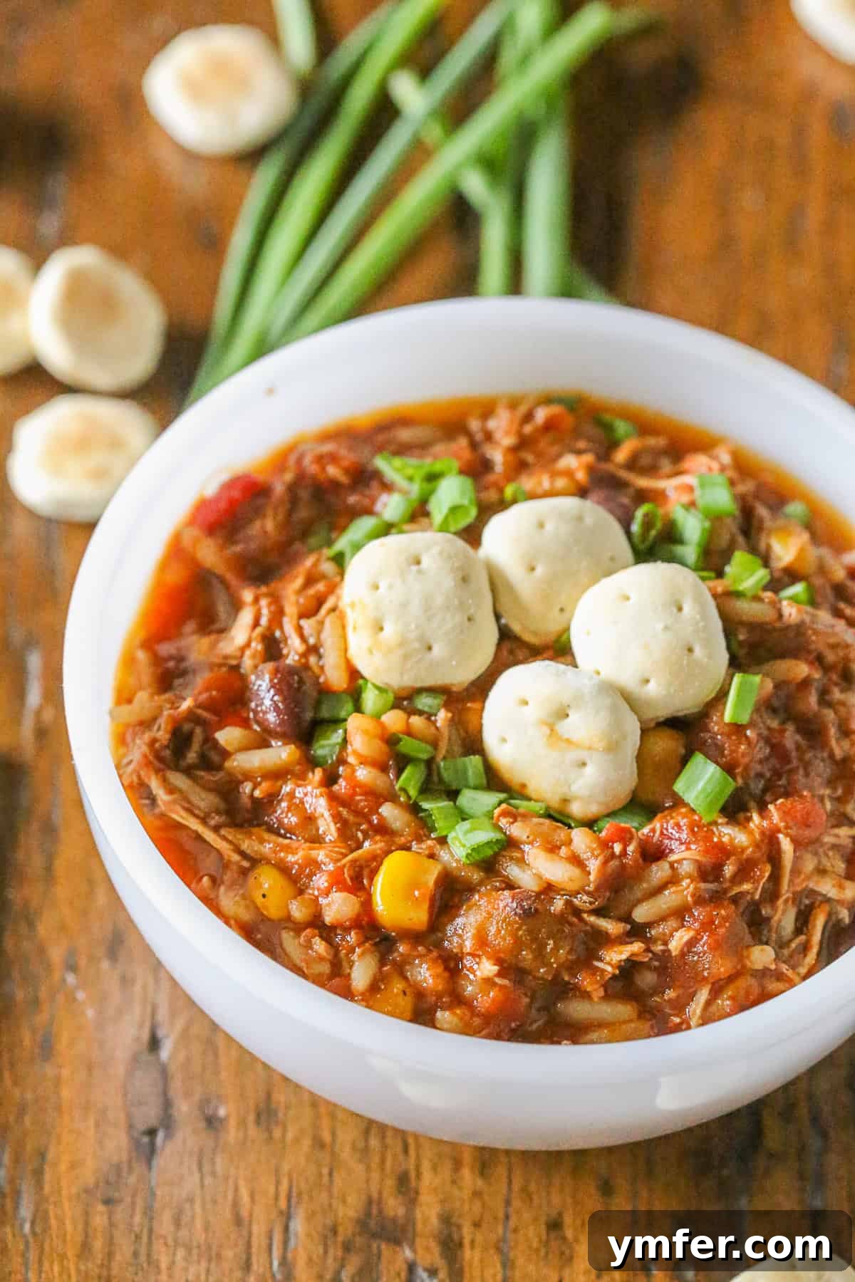 A comforting bowl of turkey wild rice chili, hearty and satisfying, topped with your favorite garnishes. A close-up of a rustic bowl of Turkey Wild Rice Chili, richly garnished and ready to be enjoyed.