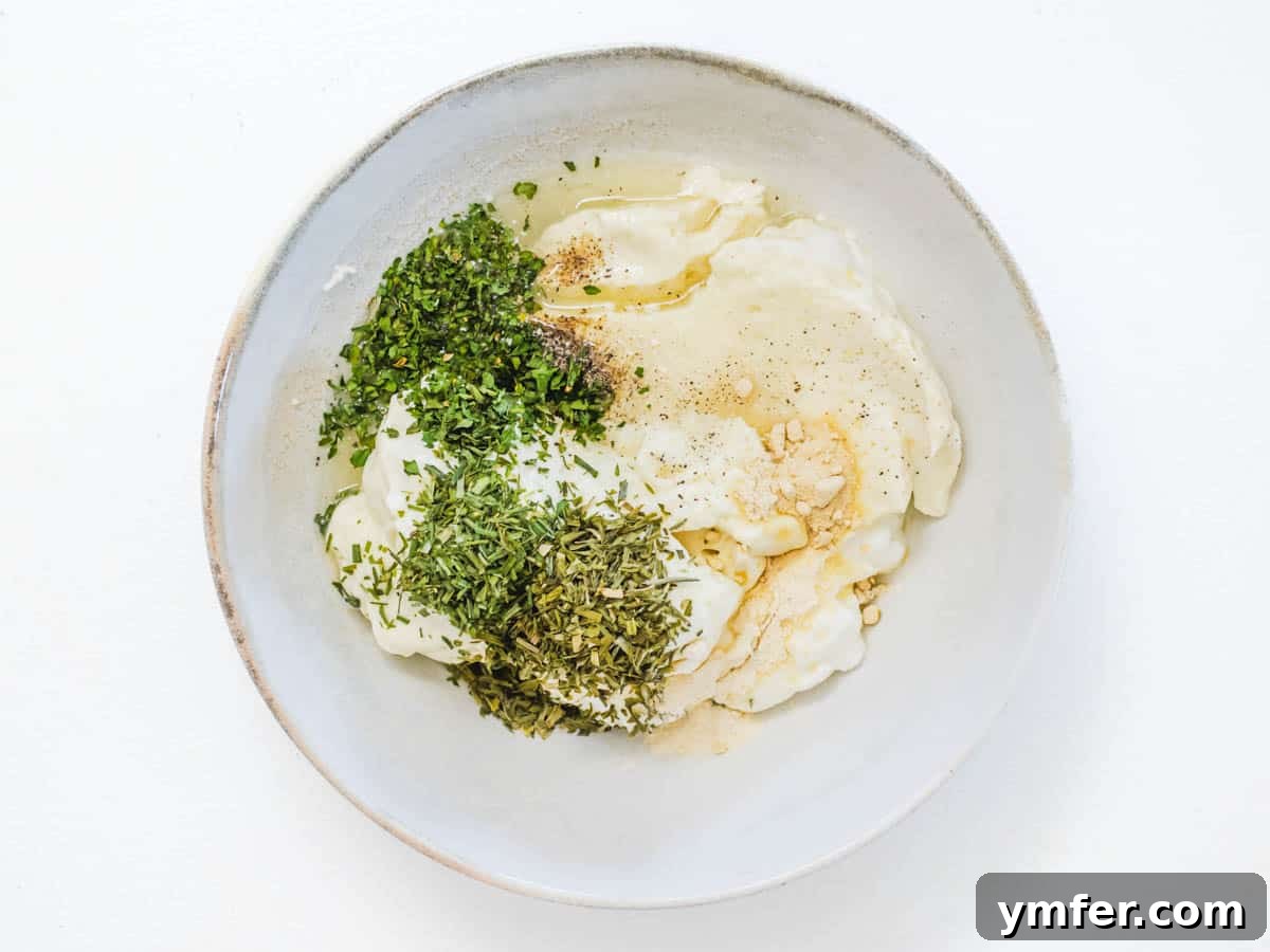 Creamy Vegan Ranch 7 Ingredients for vegan ranch dressing in a bowl before being mixed, showcasing the vibrant herbs.