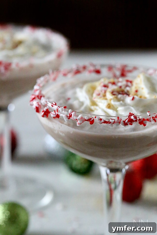 Refreshing Peppermint S'mores Martini for holiday entertaining Peppermint S'mores Martini with a candy cane rim and graham cracker crumbs