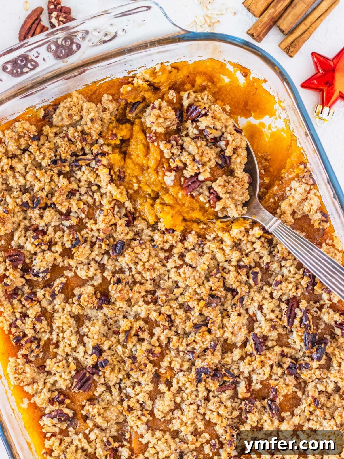 Golden Vegan Sweet Potato Delight 2 Delightful vegan sweet potato casserole generously topped with crunchy pecans and rolled oats, baked to golden perfection and ready for serving