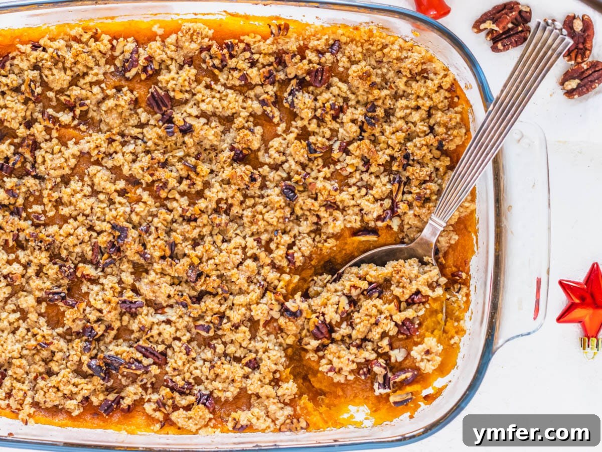 Golden Vegan Sweet Potato Delight 11 A baked vegan sweet potato casserole, still in its dish with a serving spoon, illustrating readiness for storage or serving, with a note about make-ahead options