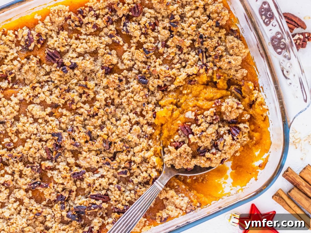 Golden Vegan Sweet Potato Delight 9 A freshly baked vegan sweet potato casserole, golden brown and crisp, ready to be served from the dish, with a serving spoon poised