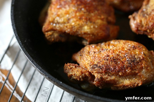 crispy pan roasted chicken thighs in a small skillet