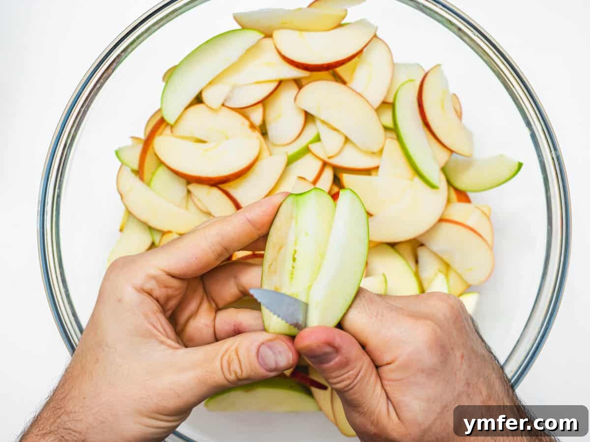 Plant-Based Apple Crumble 6 Hands slicing apples into thin wedges for the crisp filling