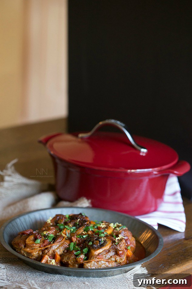 Homemade Veal Osso Buco: Tender, Flavorful, and Perfect for Special Occasions Tender Veal Osso Buco slow-braised in a rich tomato and herb sauce with white wine, served in a Dutch oven, embodying the perfect homemade holiday meal.