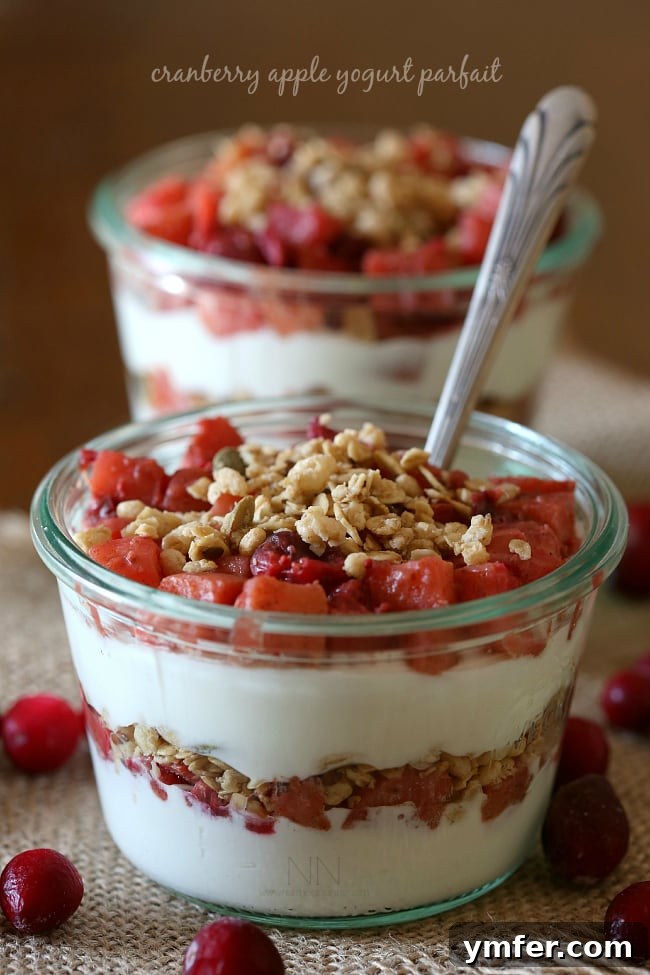 Festive Cranberry Apple Yogurt Parfait Beautifully layered Cranberry Apple Yogurt Parfait in a glass, ready to be enjoyed.