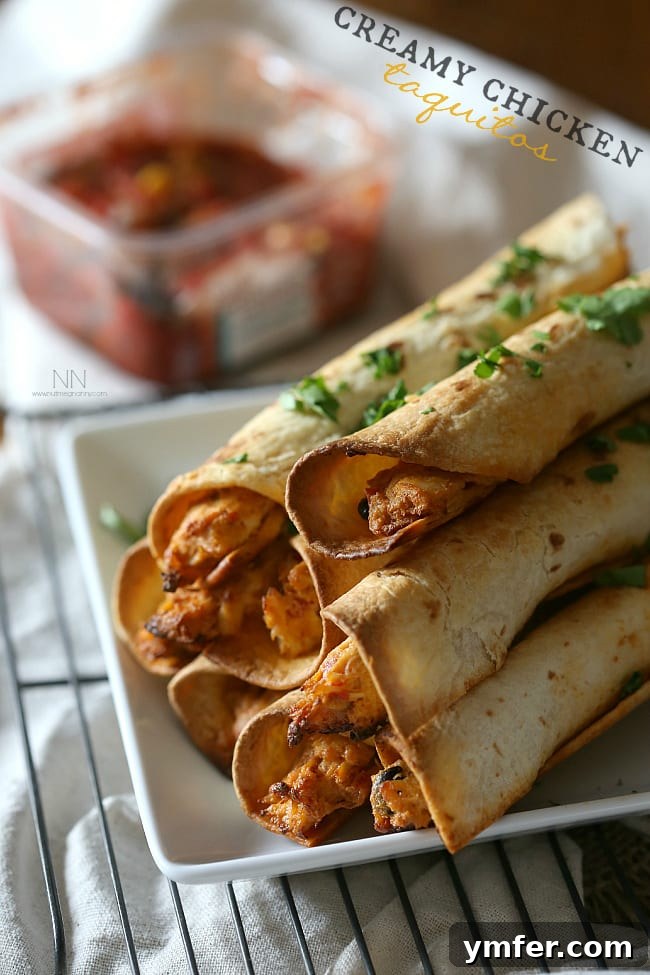 Delicious Creamy Chicken Taquitos Creamy Chicken Taquitos served on a plate with fresh cilantro garnish.