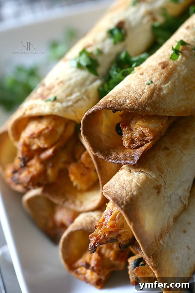 Perfectly Baked Creamy Chicken Taquitos A platter of golden-brown Creamy Chicken Taquitos, ready to be served as an appetizer or main dish.