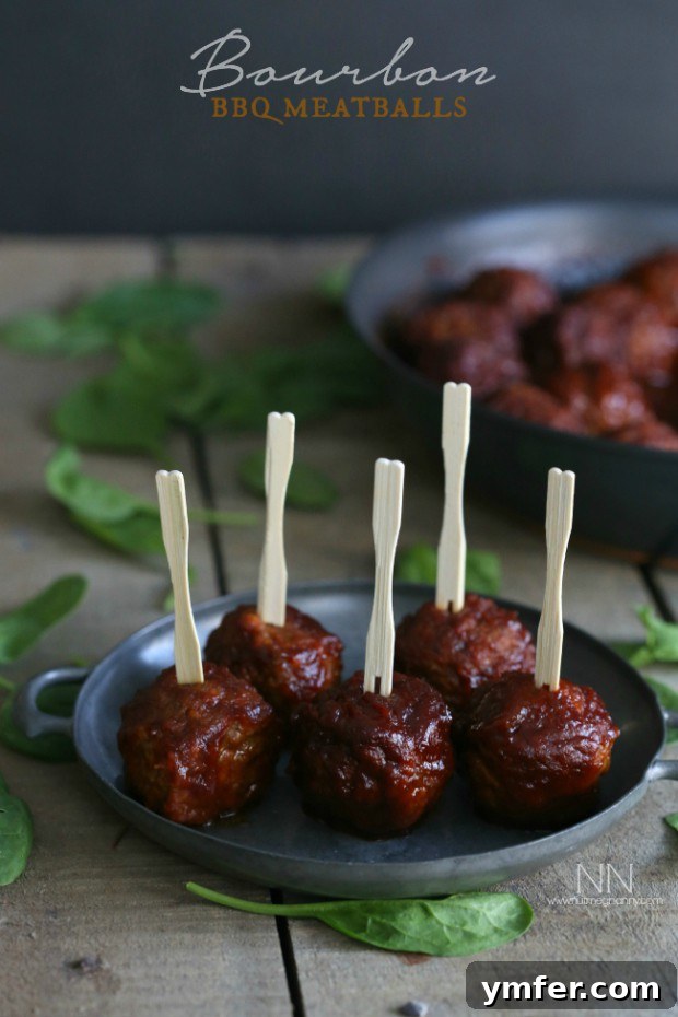 Decadent Bourbon BBQ Meatballs Recipe Plump Bourbon BBQ Meatballs generously glazed with a rich, glossy, dark sauce, garnished with fresh chopped herbs, presented as an enticing appetizer or a savory main dish.
