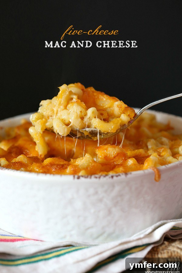 Ultimate Five Cheese Mac and Cheese Recipe A bubbling casserole dish filled with Five Cheese Mac and Cheese, showcasing its rich, golden-brown crust and gooey, melted cheese interior, promising ultimate comfort.