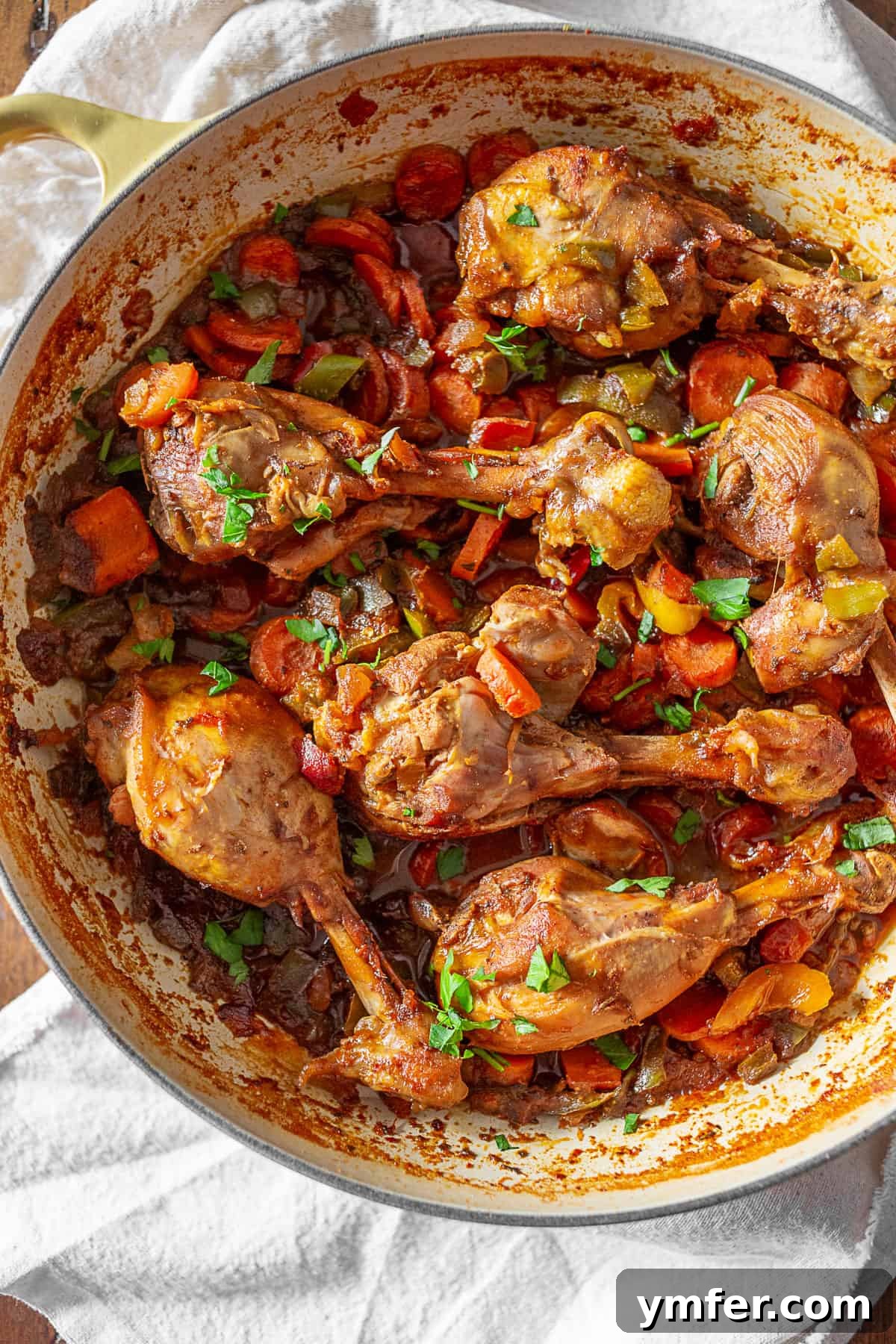 Grenadian Chicken Stew: Bone-in chicken, vegetables, and rich spices for the perfect Caribbean dish. Grenadian Chicken Stew in a large round dish, garnished with fresh cilantro.