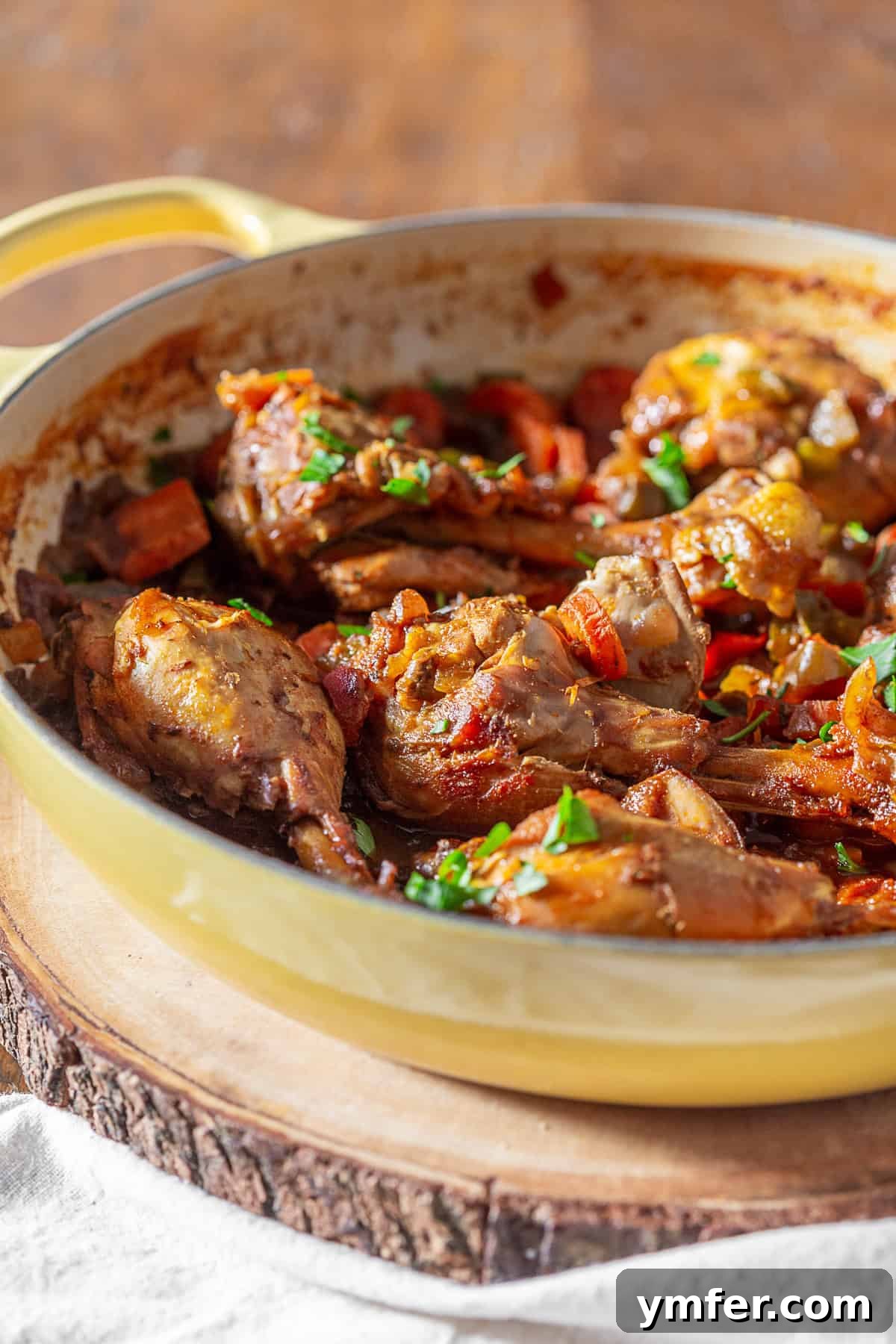 A finished Grenadian Chicken Stew, ready to serve, sprinkled with vibrant cilantro. Grenadian Chicken Stew garnished with fresh cilantro in a serving dish.