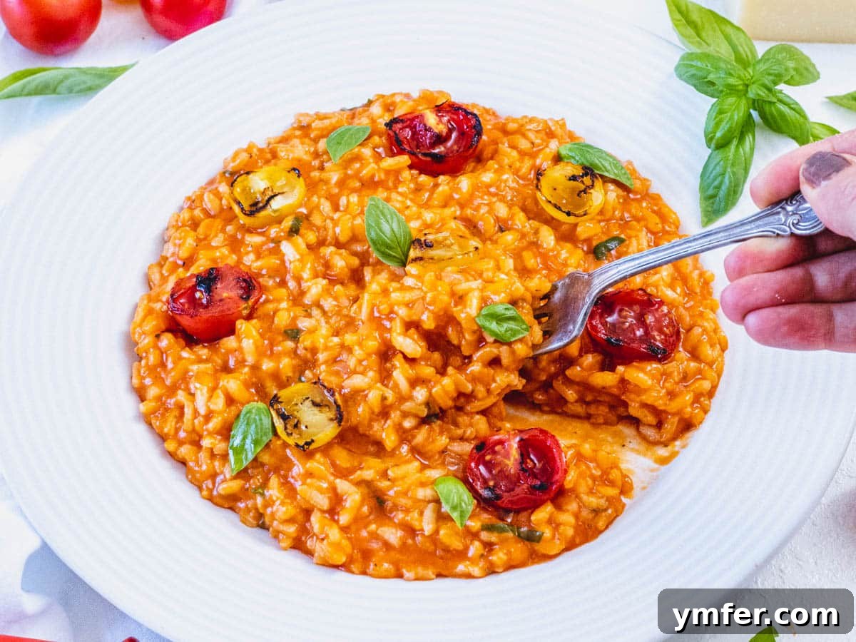 Sun-Kissed Tomato Risotto 17 Tomato risotto with hand and fork