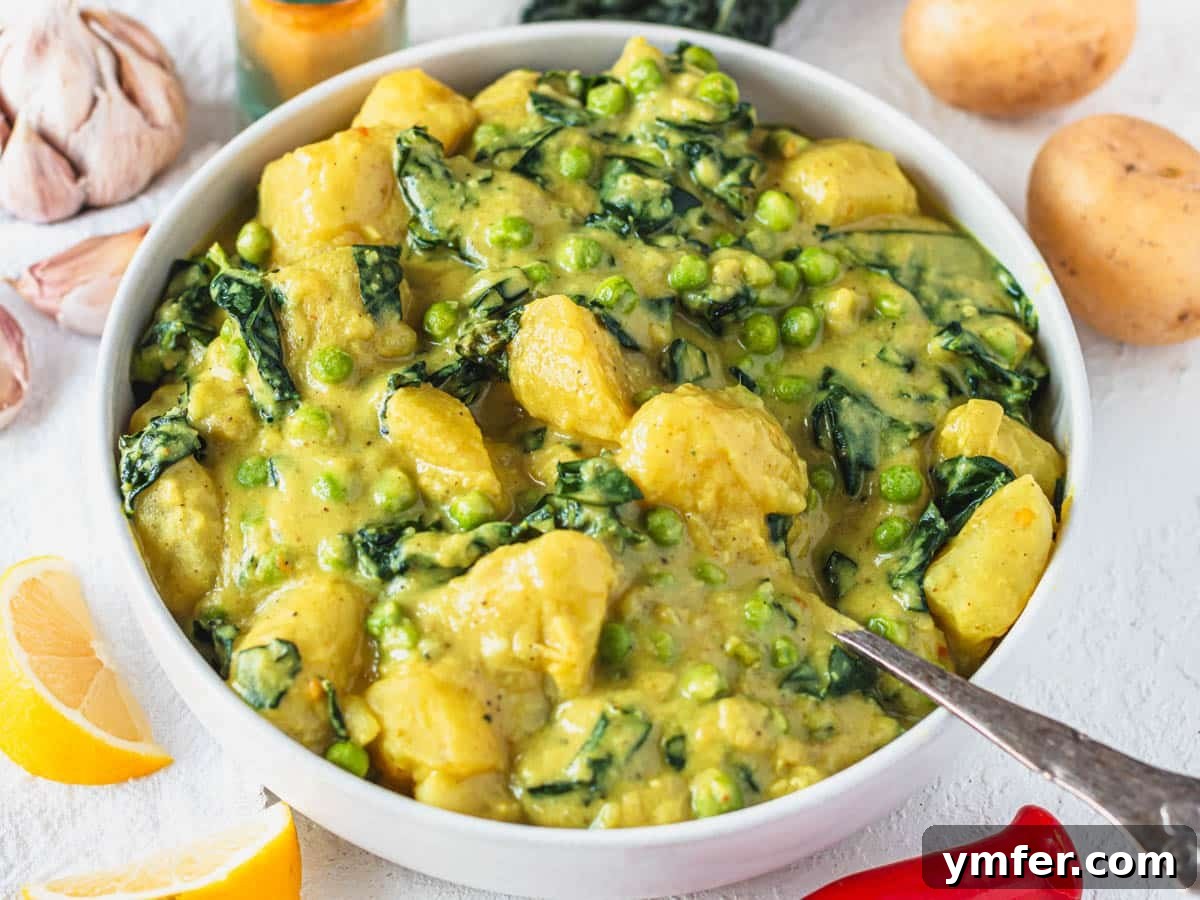 Golden Potato Delight 3 A comforting bowl of Potato curry (Aloo Curry) garnished with fresh lemon wedges, ready to be enjoyed