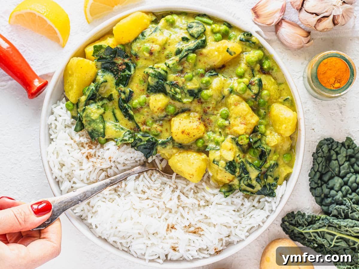Golden Potato Delight 8 A beautifully plated potato curry with basmati rice in a white bowl, garnished with fresh herbs