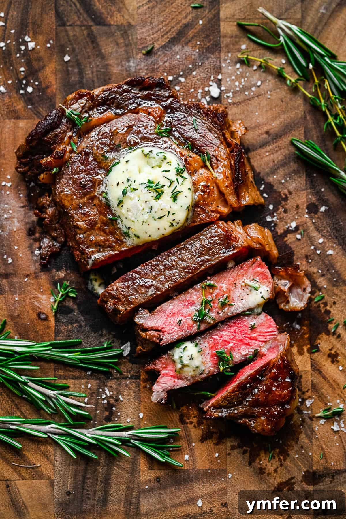 Perfect Pan-Seared Ribeye 2 Pan Fried Ribeye sliced on a cutting board, revealing a perfect medium-rare interior.