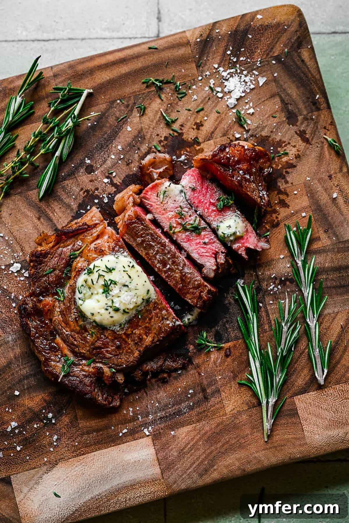 Perfect Pan-Seared Ribeye 10 Pan Fried Ribeye sliced on a cutting board, revealing a perfect medium-rare interior, ready to be served.