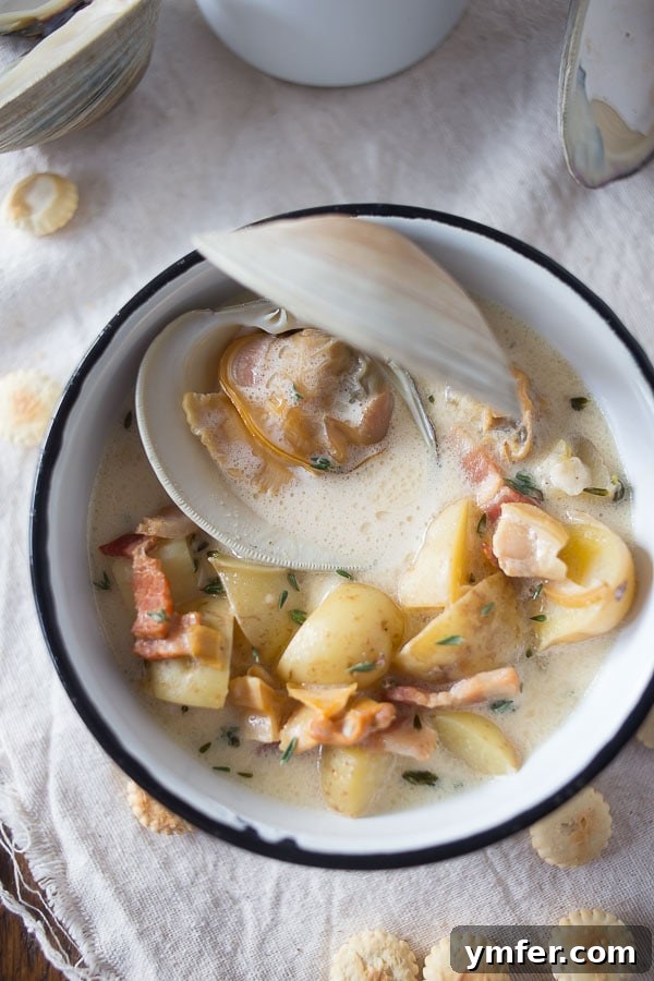 Creamy Atlantic Comfort 3 A bowl of New England Clam Chowder with oyster crackers, ready to eat.