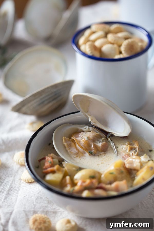 Creamy Atlantic Comfort 4 A beautifully plated bowl of New England Clam Chowder, garnished with fresh herbs and oyster crackers.