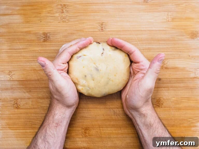 Hands shaping the biscotti dough on a worktop