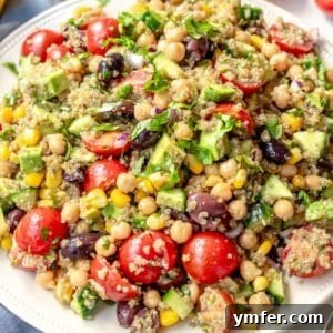 A vegan high protein meal with chickpeas, quinoa, and vegetables on a plate.