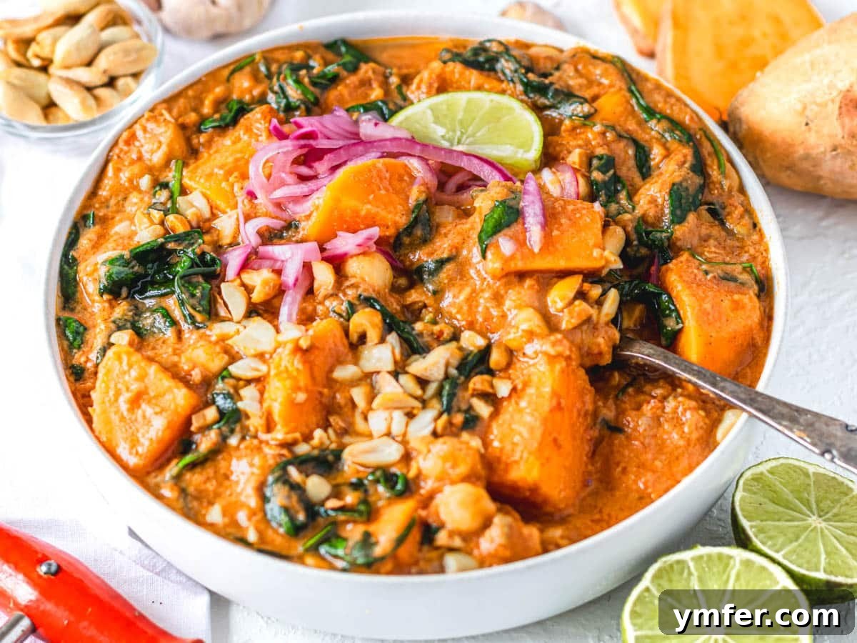 30 Plant-Based Protein Power Meals 7 Creamy African peanut stew in a white bowl with lime and pickled onions