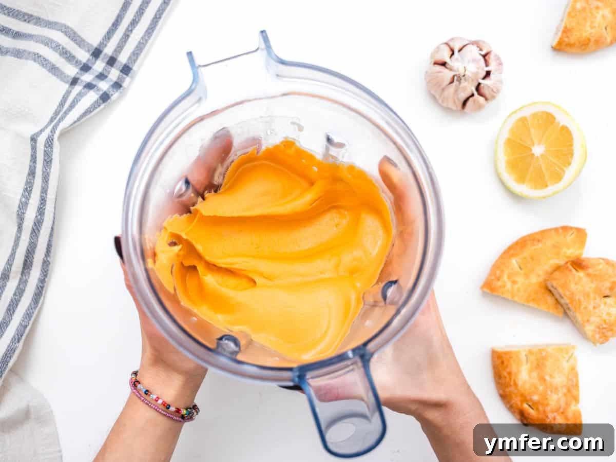 Velvety Roasted Red Pepper Hummus 10 Smooth, creamy roasted red pepper hummus after blending in a food processor.