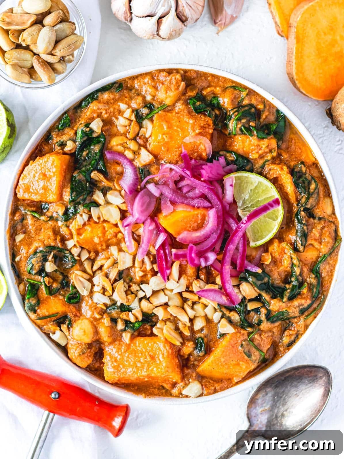 Soulful African Peanut Stew 2 African peanut stew with sweet potatoes and a spoon.