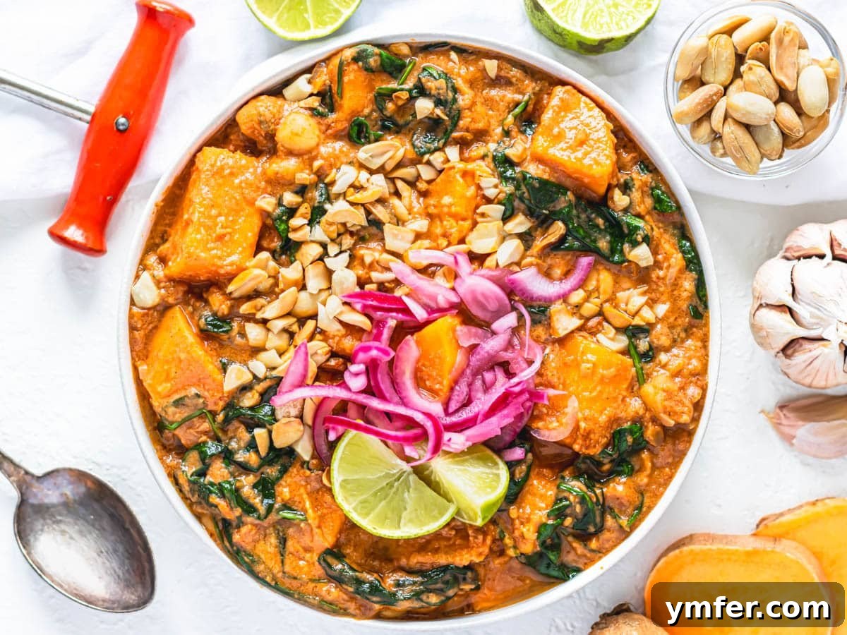 Soulful African Peanut Stew 6 African peanut stew with pickled red onions in a white bowl and peanut garnish