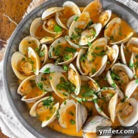 Coco-Chili Clams 6 Close-up of Spicy Coconut Milk Clams with cilantro garnish.