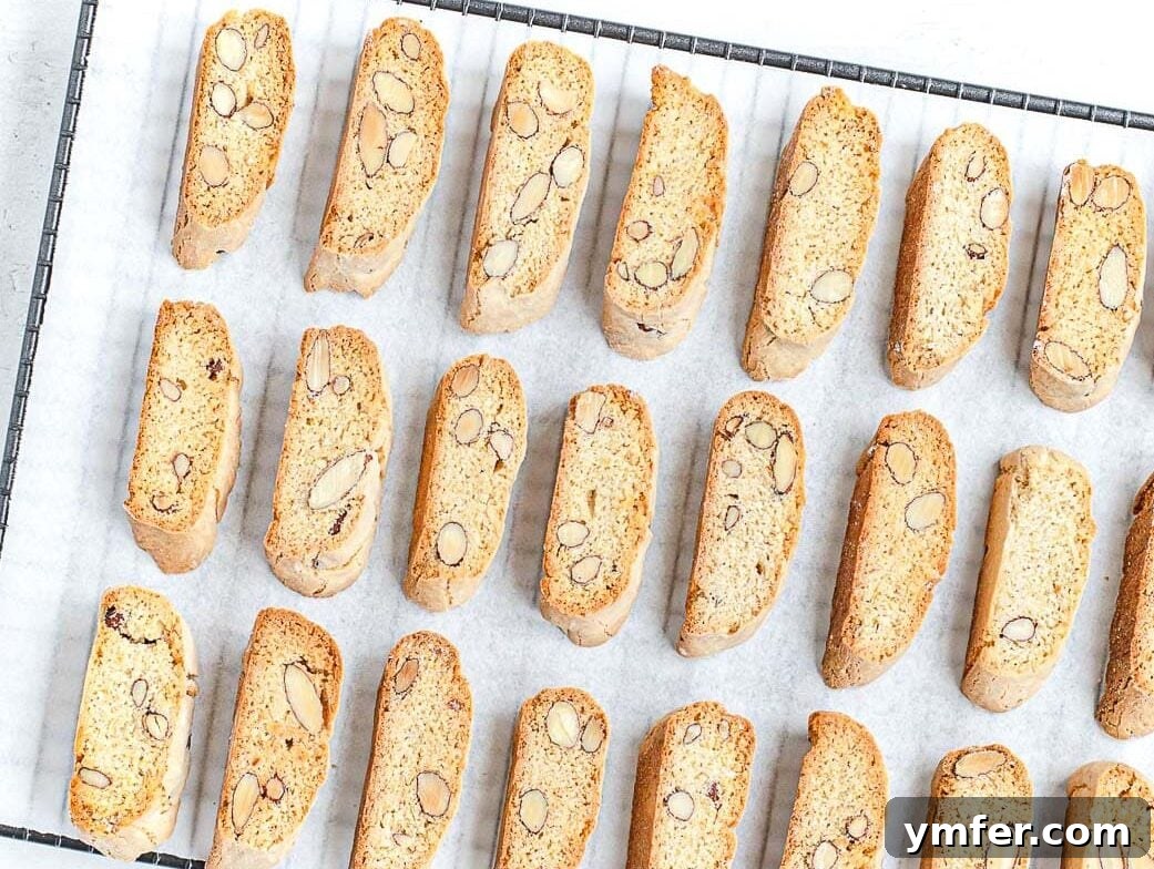 Twice Baked Italian Delights 4 Golden-brown almond biscotti cooling on a wire rack, showcasing their distinctive twice-baked texture.