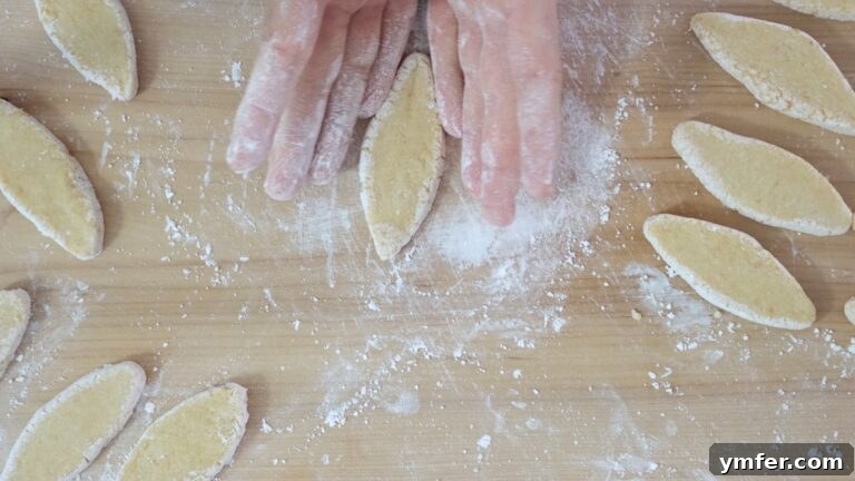 Zesty Orange Almond Delights 12 Shaping individual vegan orange almond cookie dough discs into traditional rhombus forms.