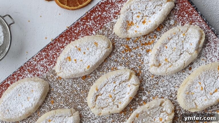 Zesty Orange Almond Delights 15 Baked vegan orange almond cookies showing their characteristic cracked tops.