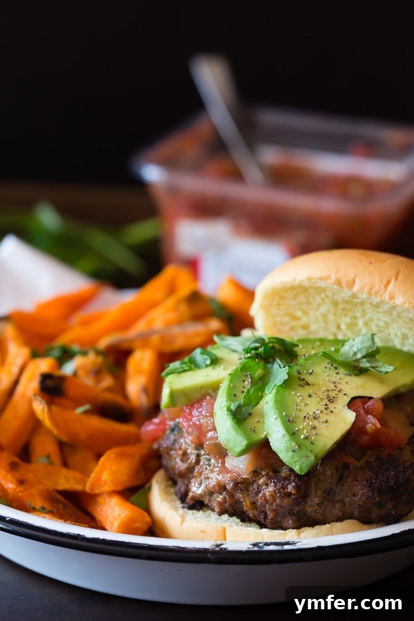 The ultimate cheesy salsa burger, perfect for your Cinco de Mayo celebration, packed with flavor and fresh Sabra salsa.