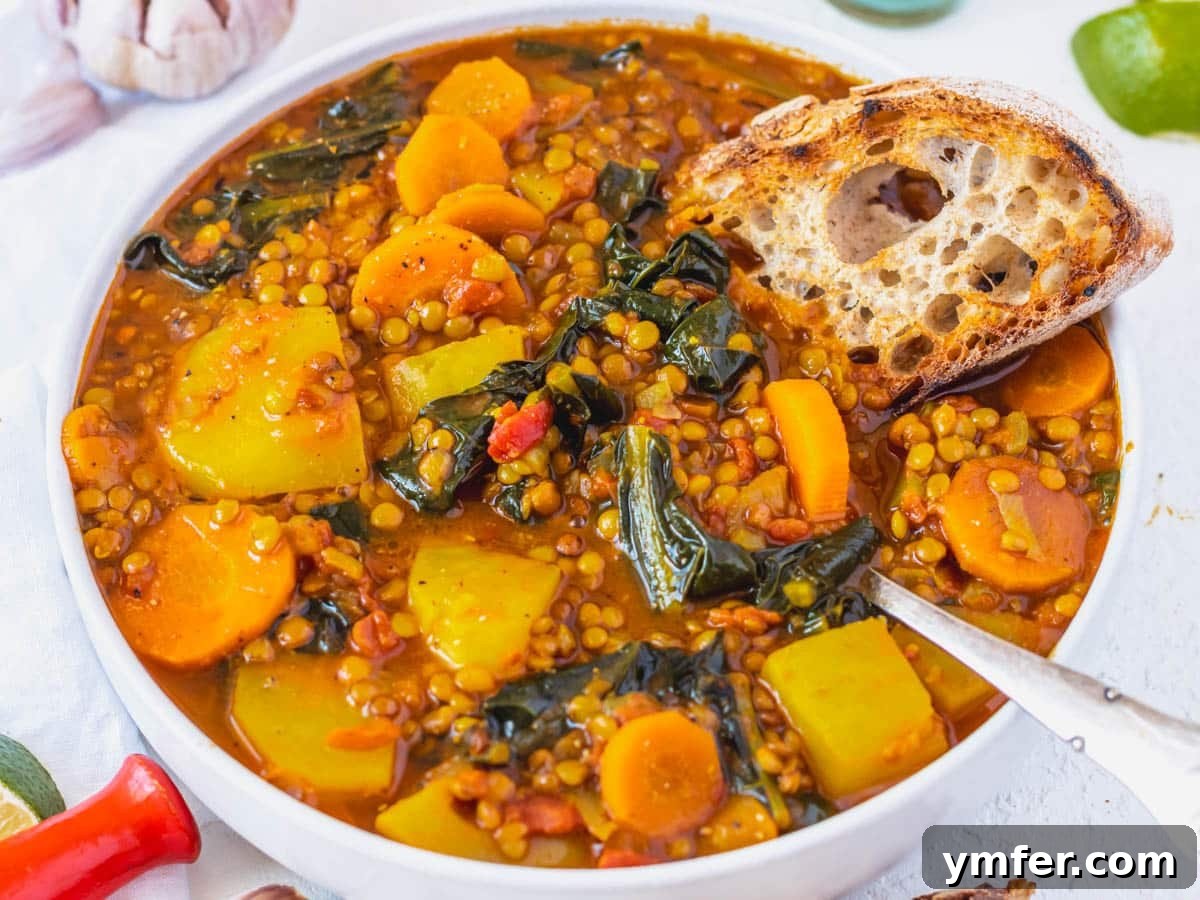 Plant-Powered Mondays 26 A warm bowl of curry lentil soup served with a slice of sourdough bread