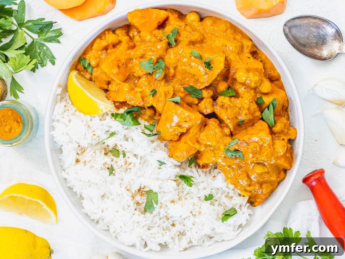 Plant-Powered Mondays 5 A bowl of vibrant sweet potato curry served with fluffy white rice and a fresh lemon wedge