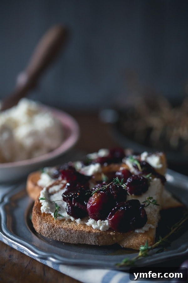 Caramelized Grape Crostini 5 A tray of roasted grape crostini with ricotta, garnished with fresh thyme