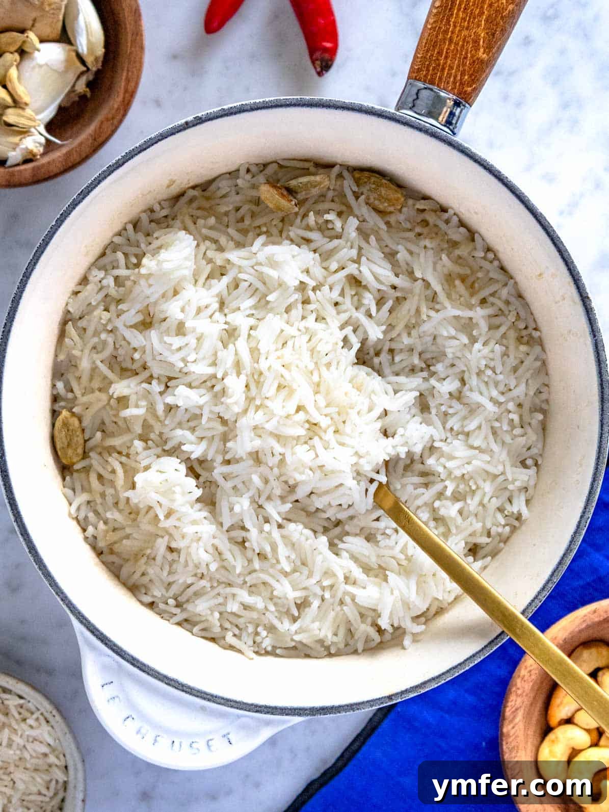 Mastering Fluffy Basmati Rice 2 A glistening white pot filled with freshly cooked, fluffy basmati rice, adorned with a golden spoon, ready for serving.