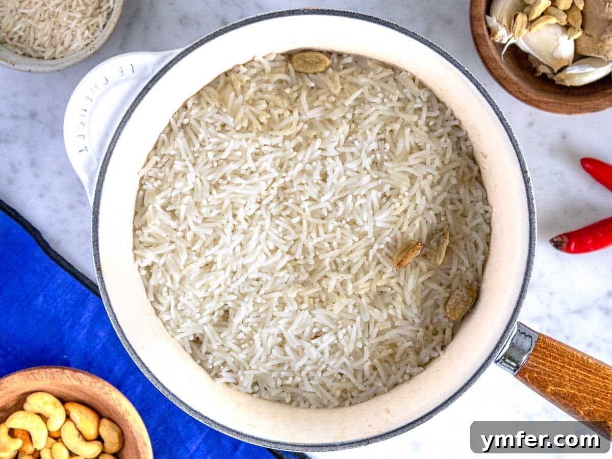 Mastering Fluffy Basmati Rice 4 A steaming saucepan filled with perfectly cooked, fluffy basmati rice, showcasing its light and separated grains.