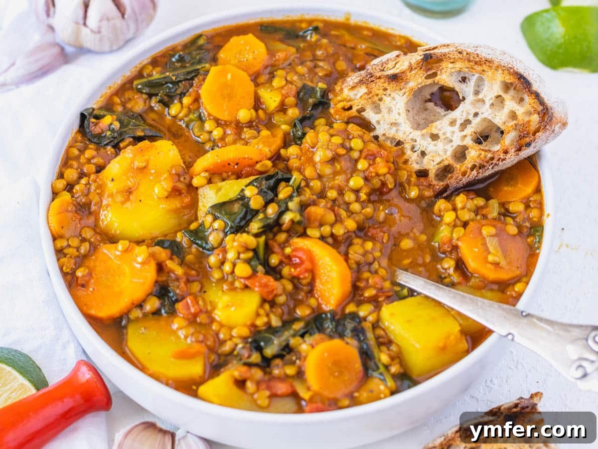 Golden Turmeric Creations 3 curry lentil soup with sourdough bread and a spoon