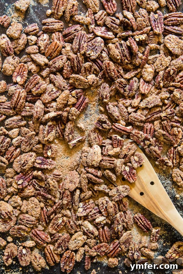 Caramelized Pecan Crunch 2 Praline Pecans on a sheet pan, freshly roasted and glistening with a sweet coating.