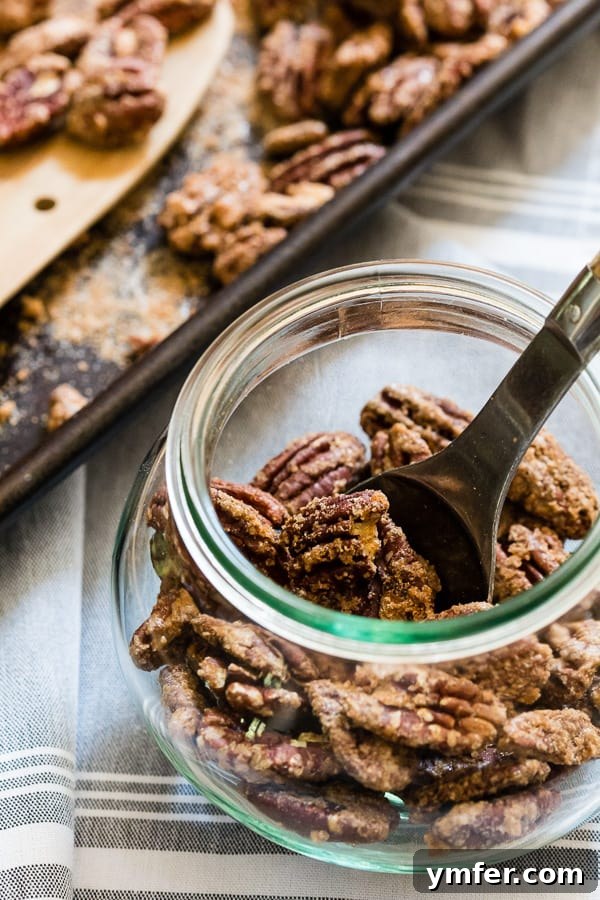 Caramelized Pecan Crunch 4 Praline Pecans in a glass jar, ready for gifting or enjoying.