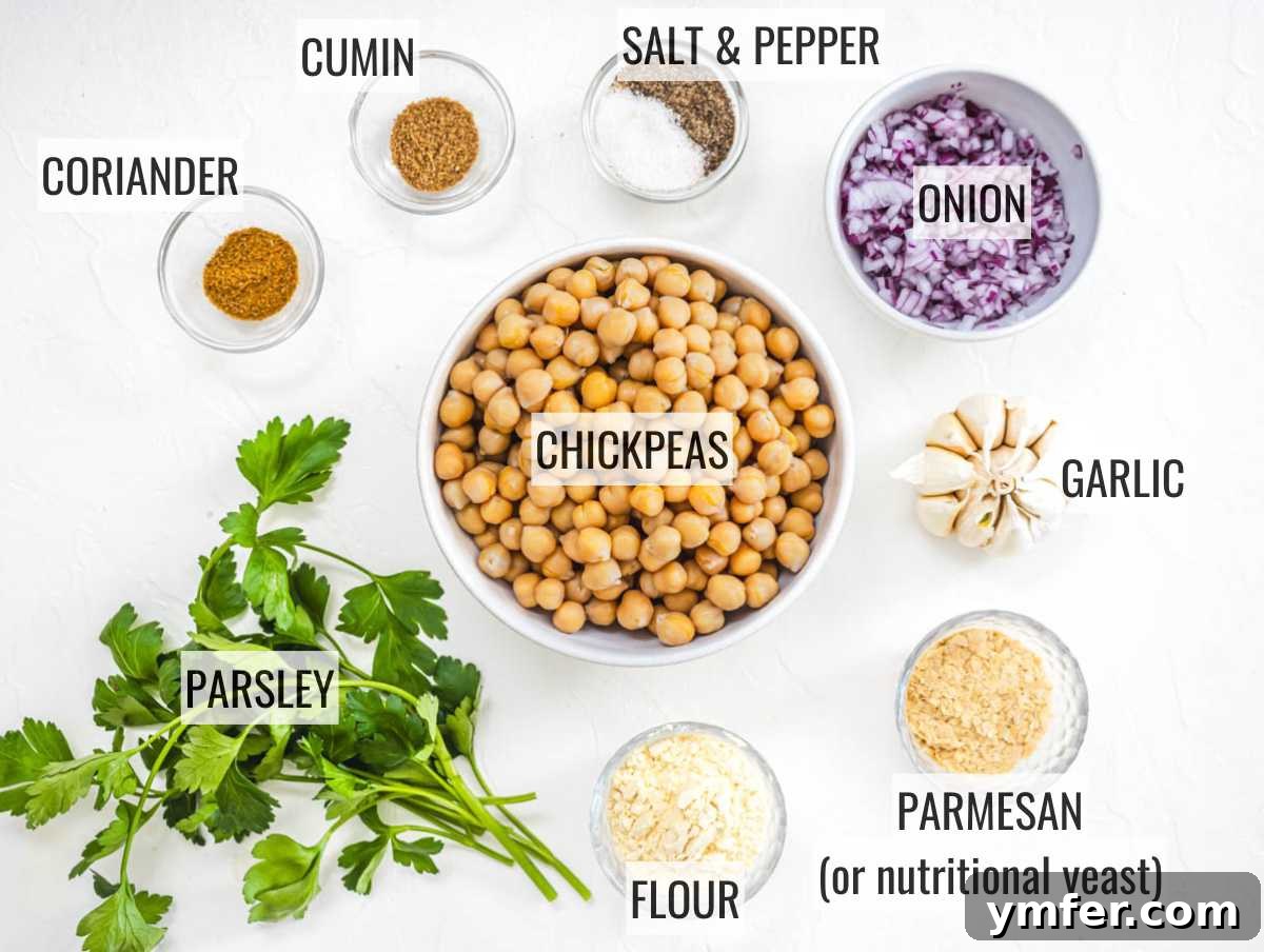 Crispy Garbanzo Bites 3 A selection of fresh ingredients laid out for making chickpea fritters, including chickpeas, herbs, and spices.