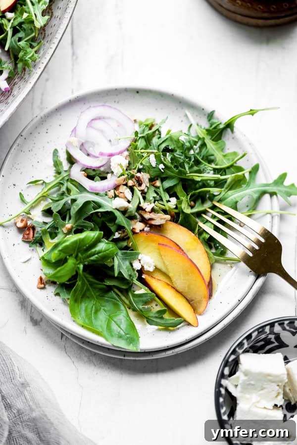 Sweet and Savory Peach Feta 4 A serving of Peach Feta Salad on a white plate, ready to be enjoyed.