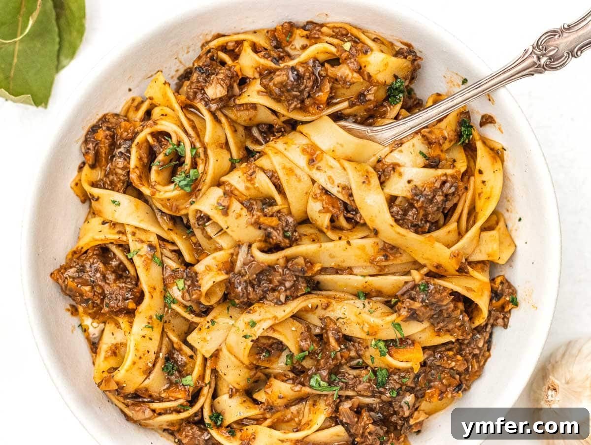 Simple Celery Recipes 26 Rich Mushroom Bolognese served with a fork, ready to be enjoyed with pasta.