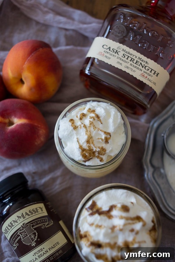 Velvet Bourbon Peach Swirl 3 Vanilla Peach Bourbon Milkshake, a luxurious blend of vanilla bean paste, fresh peaches, and bourbon, garnished with whipped cream.