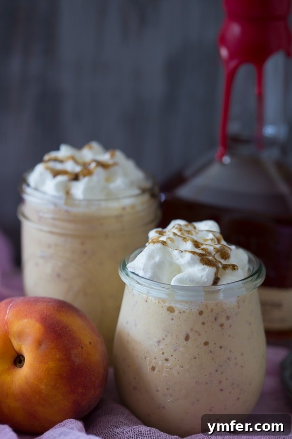 Velvet Bourbon Peach Swirl 4 Close-up of a creamy Vanilla Peach Bourbon Milkshake, highlighting its rich texture and flecks of vanilla bean.