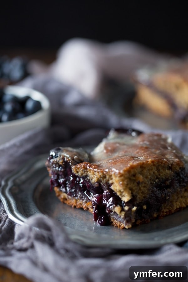 Glazed Blueberry Fritter Coffee Cake 2 This blueberry fritter cake is the perfect way to celebrate the bounty of summer - sweet cinnamon scented cake with a warm blueberry center topped with vanilla bean glaze. It's like you favorite bakery fritter but in easy to make cake form. Trust me, you'll love the taste of the cake and it's perfect for breakfast or dessert.
