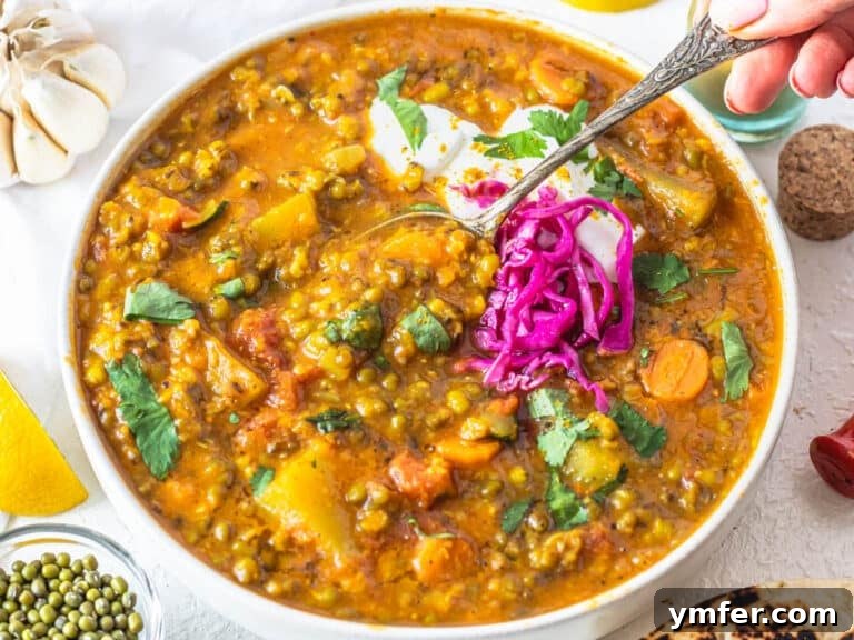 Jade Bean Elixir 19 Mung bean soup with pickled cabbage and a hand holding a silver spoon