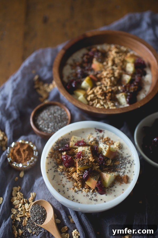 Spiced Apple Pie Smoothie Bowl 4 Two inviting Apple Pie Smoothie Bowls presented side-by-side, showcasing their appealing texture and abundant toppings for a satisfying meal.